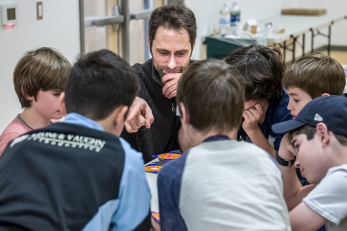Dan Finkel ’02 works with children on their math skills.